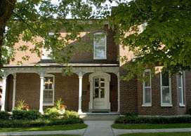 Breeze house on Centre College campus, two story brick building with columns.